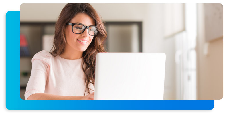 Woman on laptop with glasses researching invisible braces